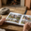 Manos abriendo un álbum de fotos con tapa de madera sobre una mesa de roble, regalo para un cazador